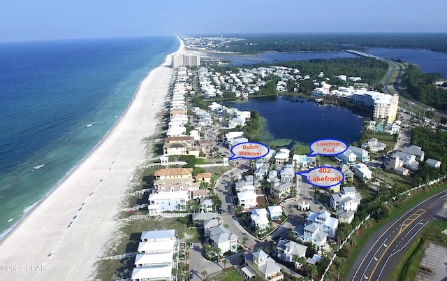 drone / aerial view with a beach view and a water view