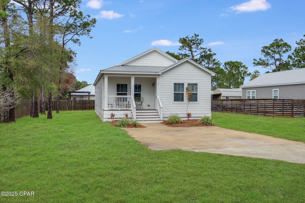 rear view of house with a yard and covered porch