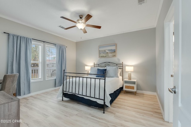 bedroom featuring ceiling fan, crown molding, and light hardwood / wood-style flooring