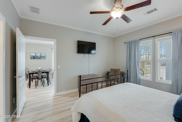 bedroom featuring ceiling fan, light wood-type flooring, and ornamental molding