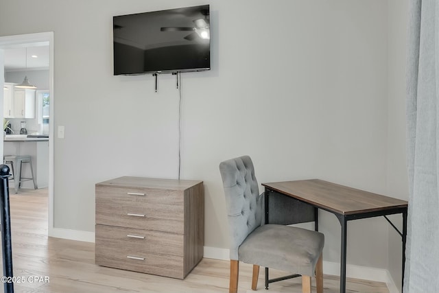 home office with ceiling fan and light hardwood / wood-style flooring