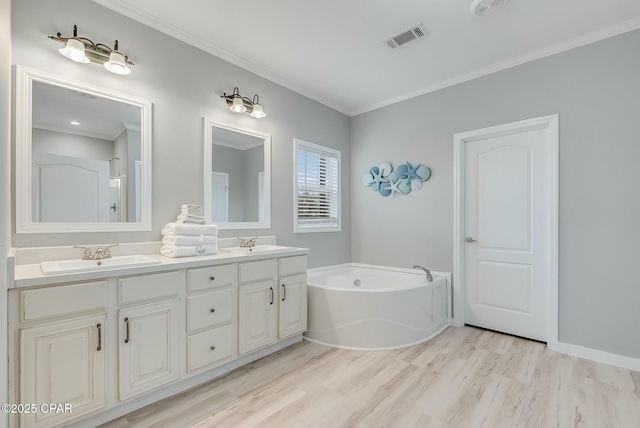 bathroom with crown molding, a bathtub, wood-type flooring, and vanity