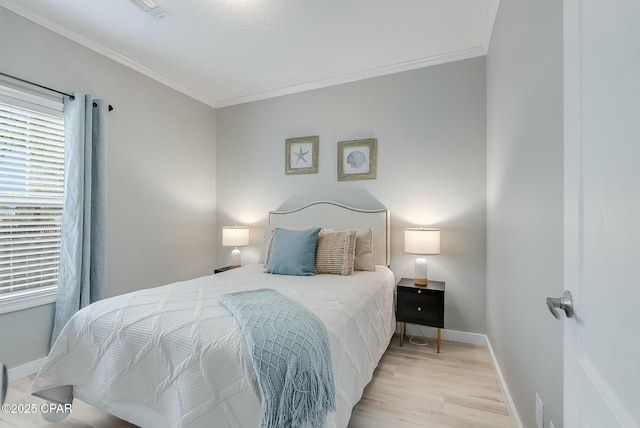 bedroom featuring light hardwood / wood-style floors and crown molding