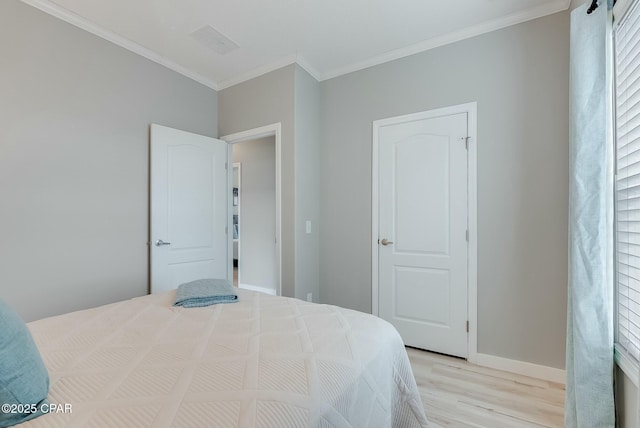 bedroom featuring light hardwood / wood-style floors and crown molding