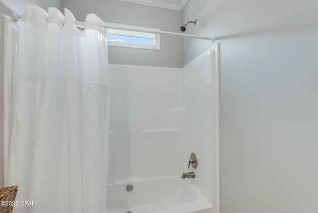 bathroom with shower / bath combo and crown molding