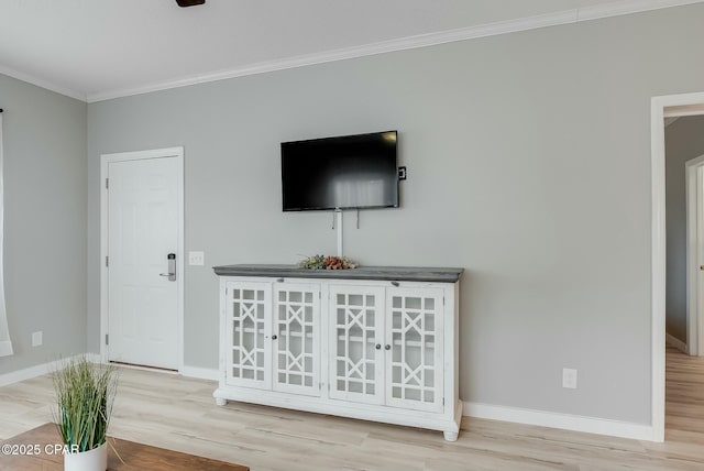 unfurnished living room with crown molding and light hardwood / wood-style flooring