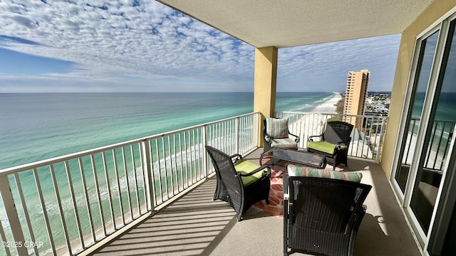 balcony with a view of the beach and a water view