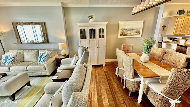 living room with crown molding and hardwood / wood-style flooring