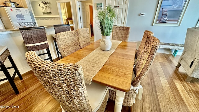 dining space featuring wood-type flooring