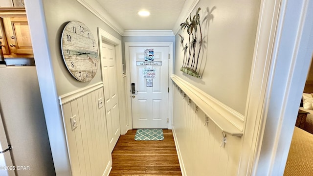 doorway to outside with dark hardwood / wood-style flooring and ornamental molding