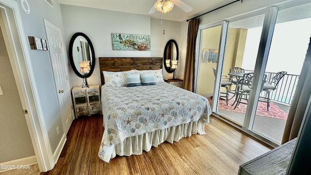 bedroom featuring ceiling fan, access to exterior, and hardwood / wood-style flooring