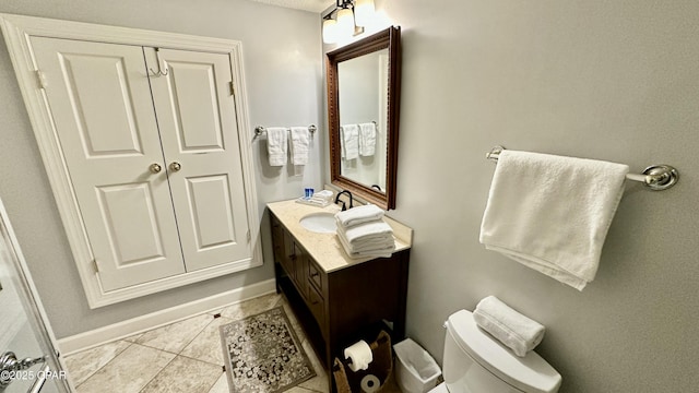 bathroom featuring tile patterned floors, vanity, and toilet