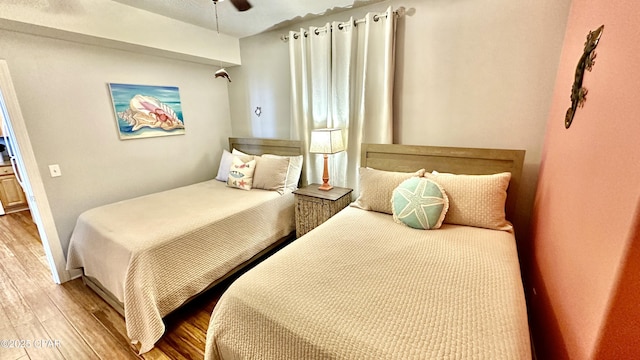 bedroom with ceiling fan and hardwood / wood-style flooring