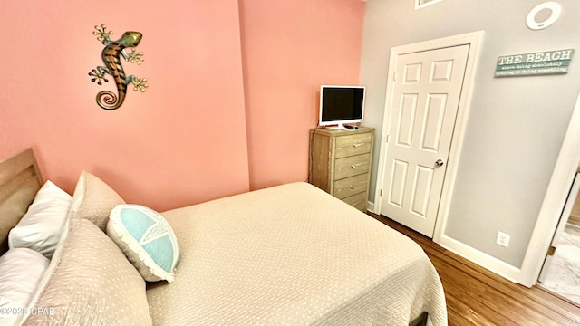 bedroom with hardwood / wood-style floors