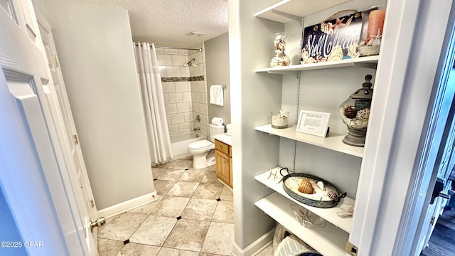 full bathroom featuring a textured ceiling, toilet, vanity, and shower / bath combination with curtain