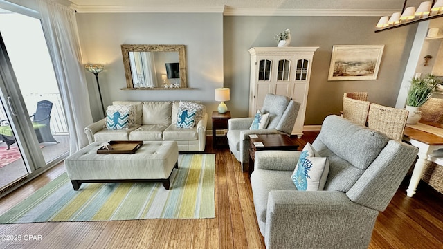 living room with a healthy amount of sunlight, crown molding, and hardwood / wood-style floors