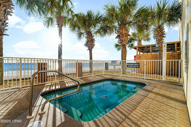 view of swimming pool with a water view, a hot tub, and a patio