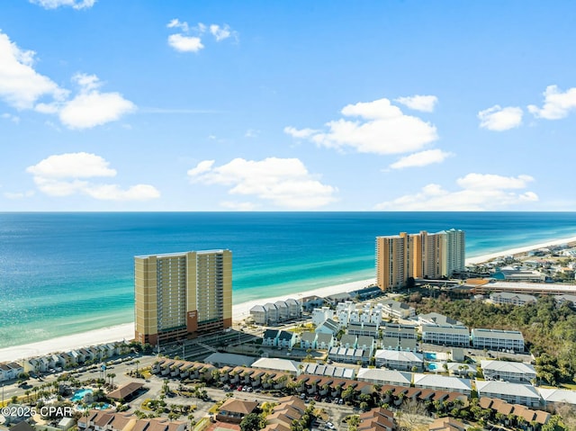 birds eye view of property featuring a beach view and a water view