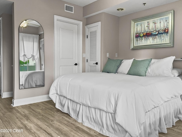 bedroom with wood-type flooring and a closet