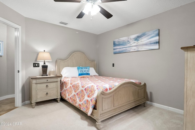 bedroom featuring ceiling fan and light carpet