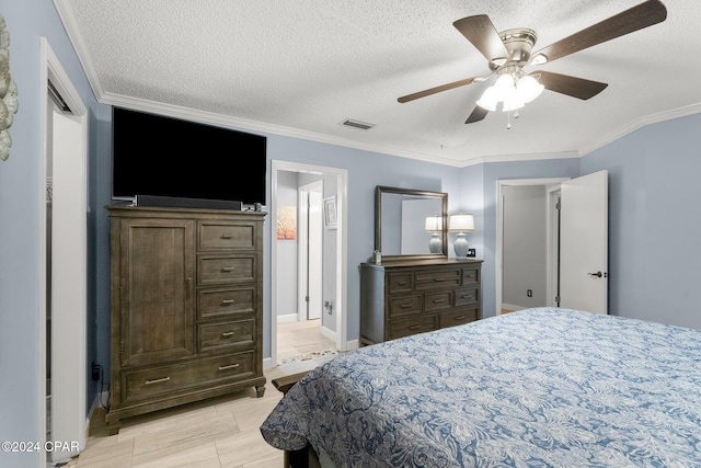 bedroom with ceiling fan, crown molding, and a textured ceiling