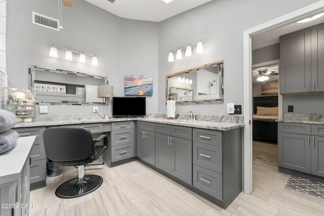 bathroom featuring ceiling fan and vanity