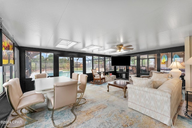 sunroom / solarium with ceiling fan and a healthy amount of sunlight