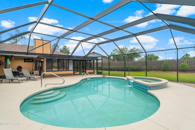 view of swimming pool with a lanai, an in ground hot tub, and a patio area