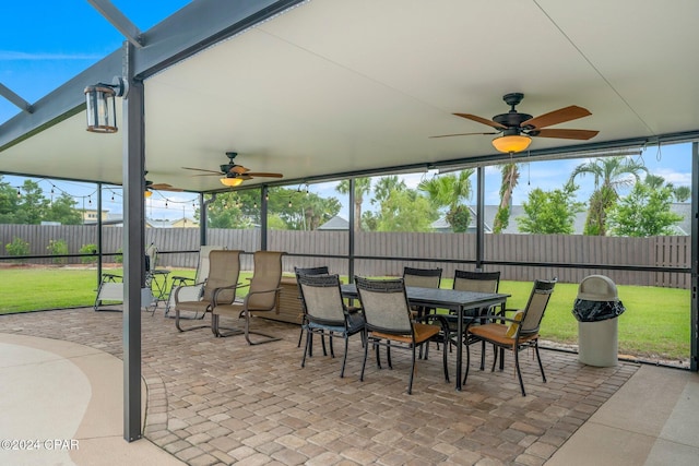 sunroom / solarium featuring ceiling fan