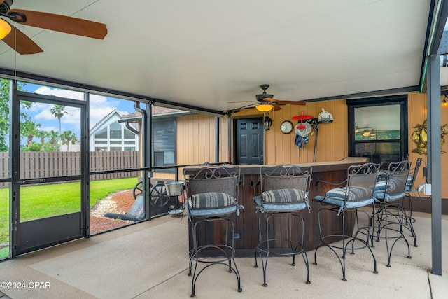 sunroom / solarium featuring ceiling fan