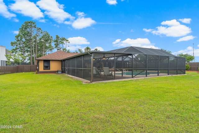 back of house with a yard, glass enclosure, a fenced in pool, and a patio area