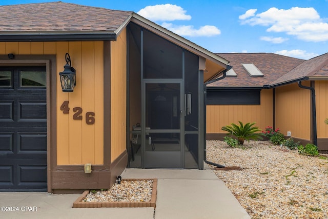 view of exterior entry with a garage