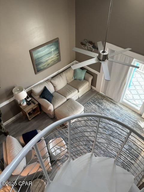 unfurnished living room featuring ceiling fan and hardwood / wood-style flooring