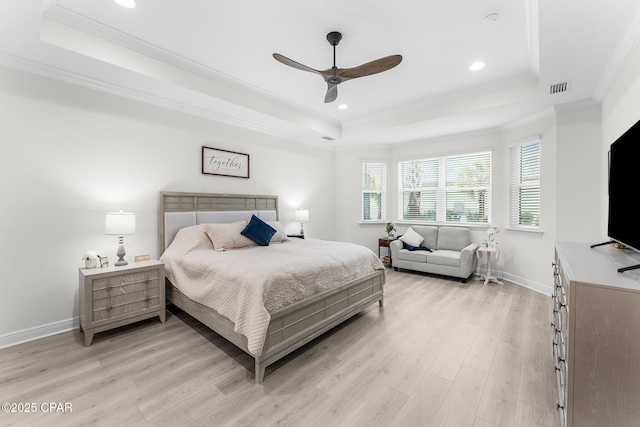 bedroom with a raised ceiling, ceiling fan, and light hardwood / wood-style floors