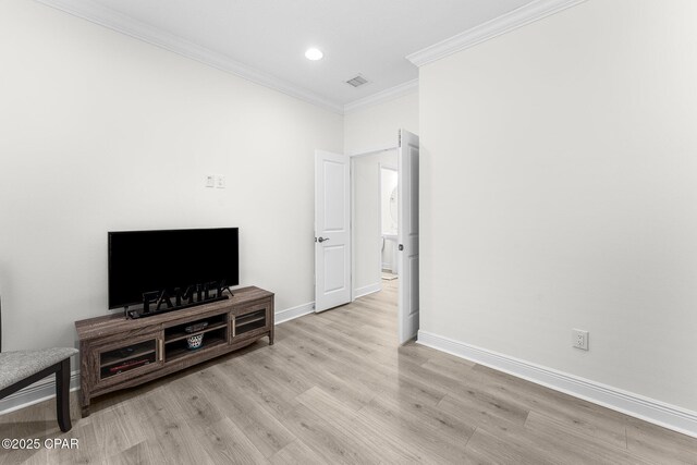 living room featuring light hardwood / wood-style floors and crown molding