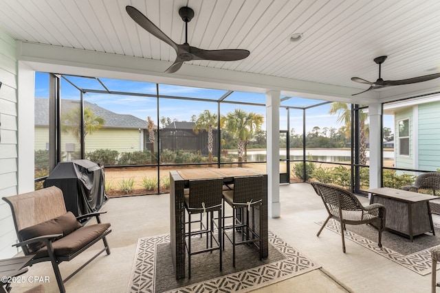 sunroom / solarium with wooden ceiling and ceiling fan