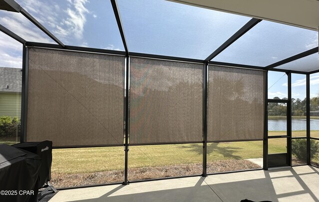 back of property with a sunroom and a lawn