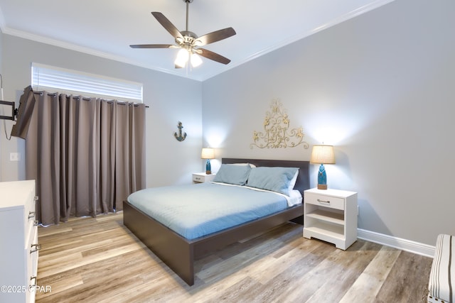 bedroom featuring light wood finished floors, ceiling fan, baseboards, and crown molding