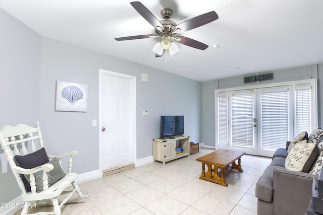 living room with a ceiling fan, french doors, baseboards, and light tile patterned floors