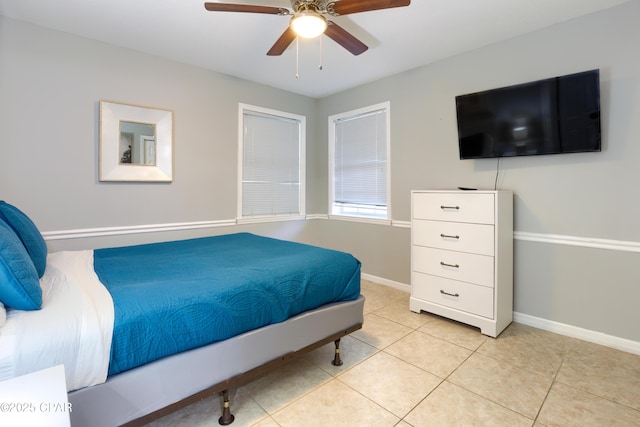 bedroom featuring baseboards, a ceiling fan, and light tile patterned flooring