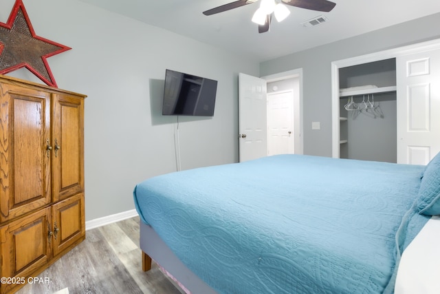 bedroom with a ceiling fan, visible vents, baseboards, a closet, and light wood-type flooring