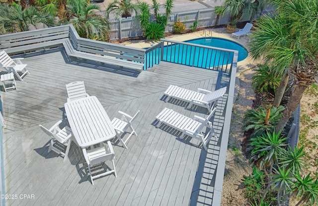 exterior space featuring a deck, fence, and a fenced in pool