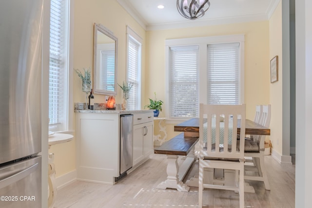 dining space featuring crown molding