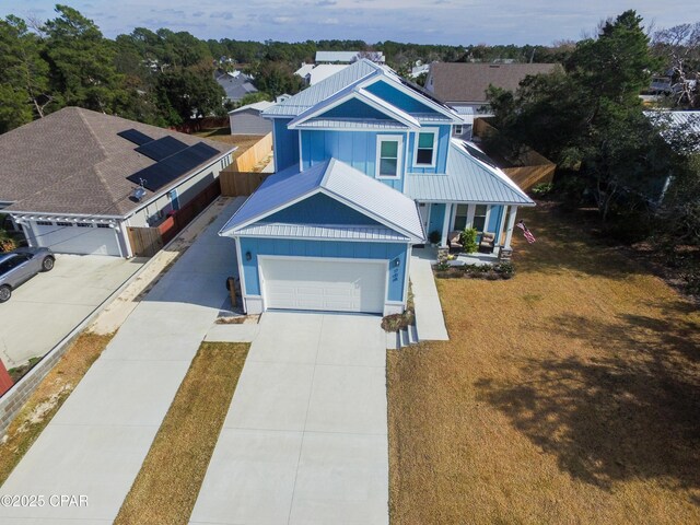 view of front facade with a garage, a front yard, and covered porch