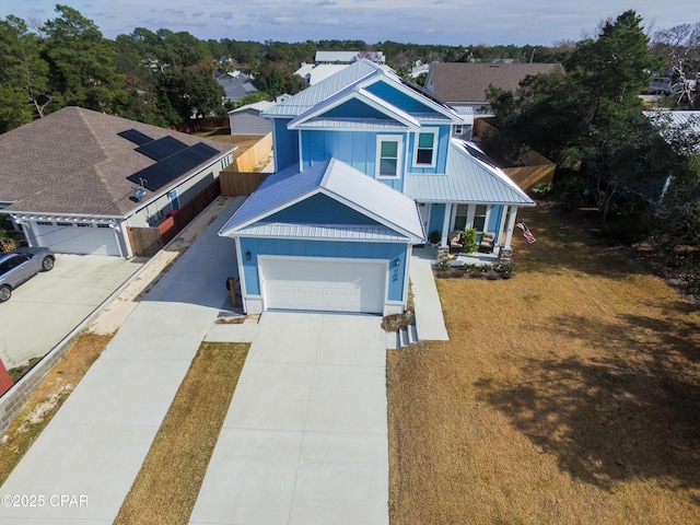 view of front facade with a garage, a front yard, and covered porch