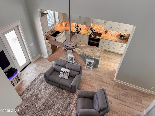 living room with sink and light wood-type flooring