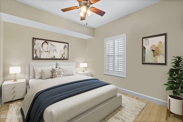 bedroom with ceiling fan and light hardwood / wood-style floors