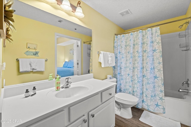 full bathroom with toilet, vanity, hardwood / wood-style flooring, a textured ceiling, and shower / bath combo with shower curtain