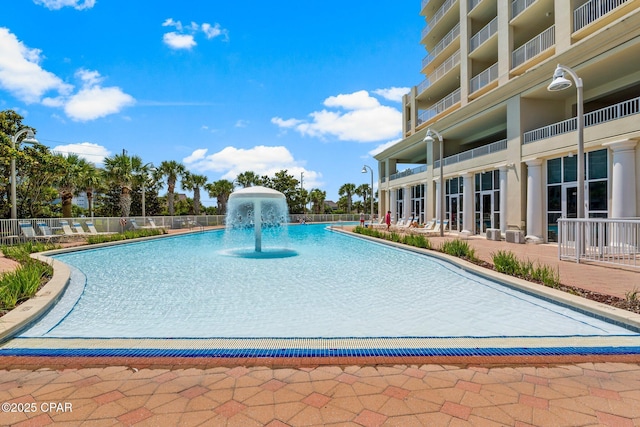 view of swimming pool with pool water feature