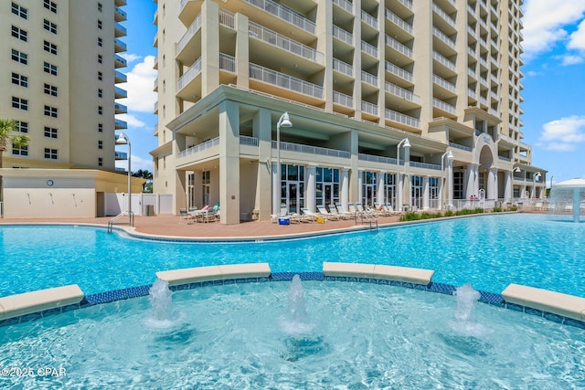 view of swimming pool with pool water feature